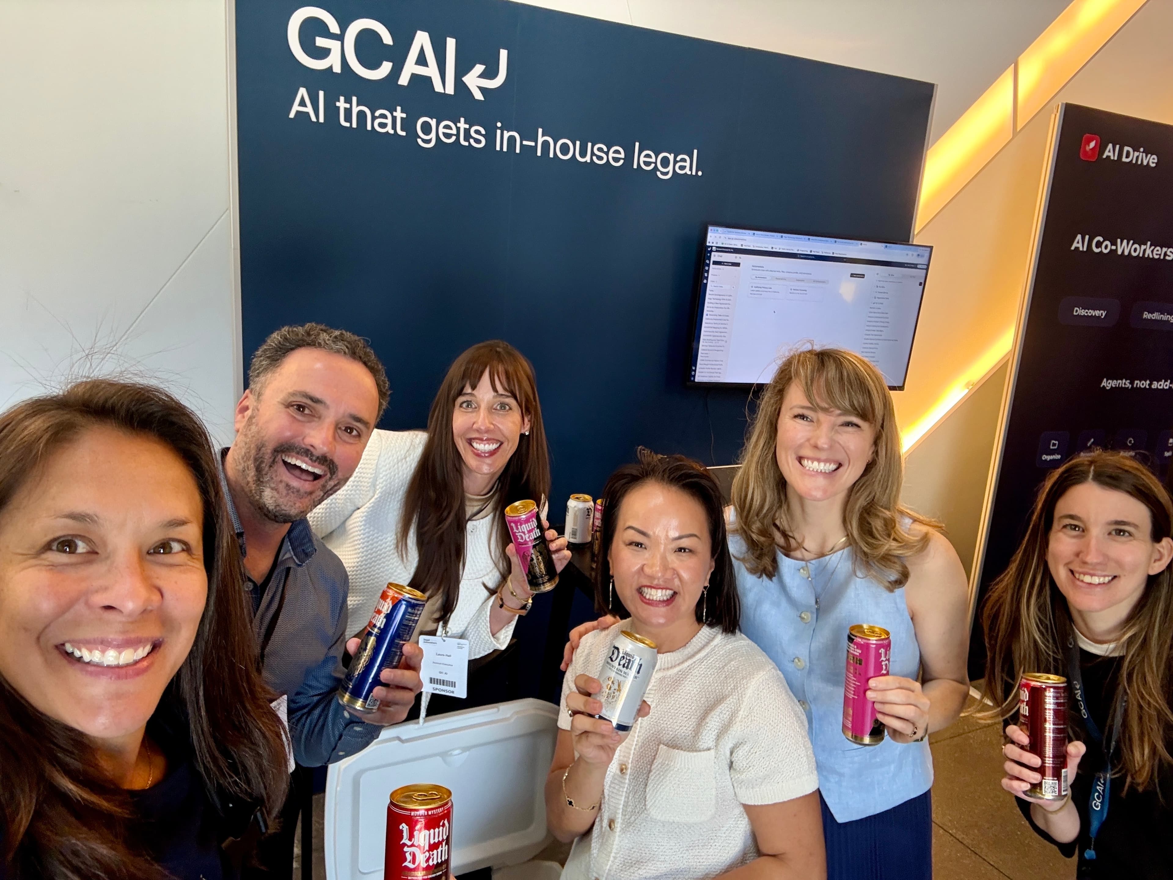 GC AI teammates smiling at a conference booth