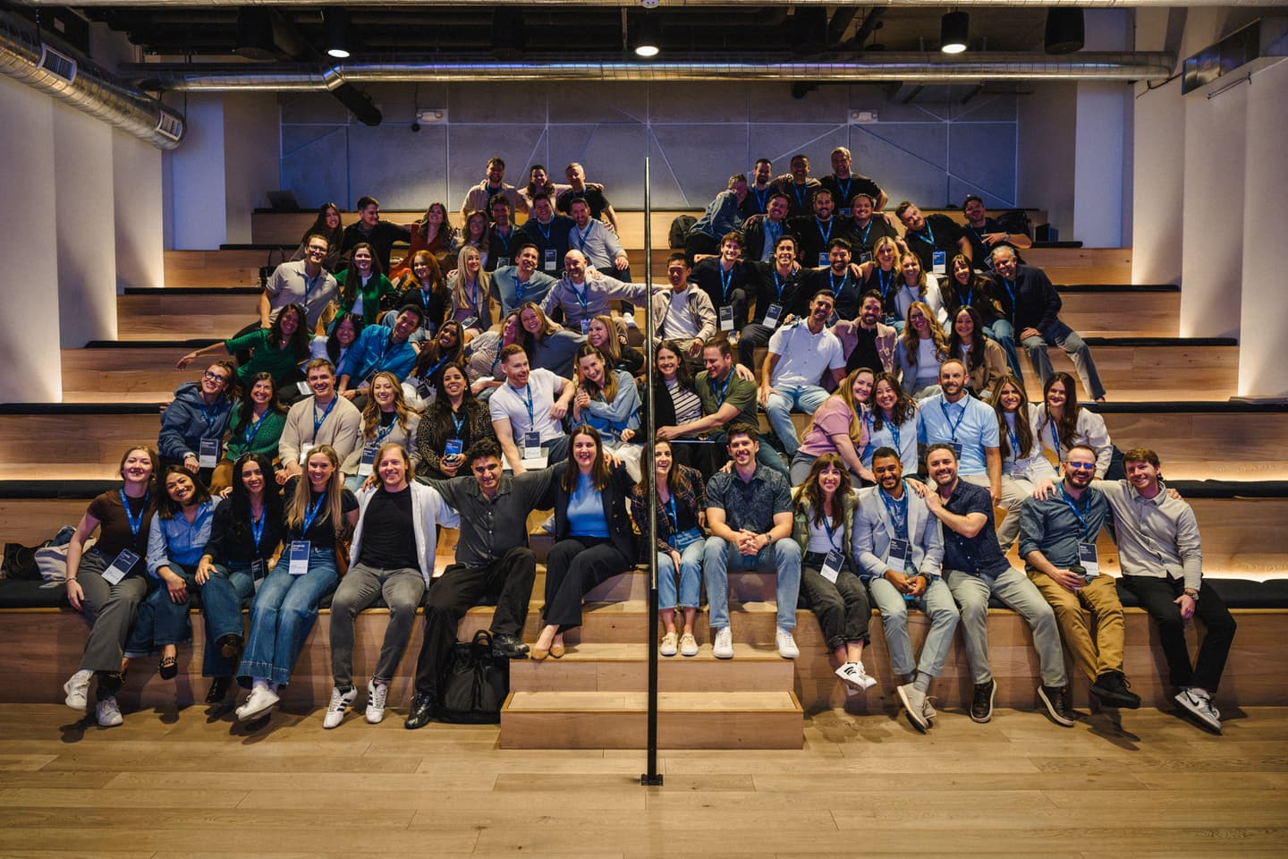 The GC AI team gathered for a group photo on tiered steps